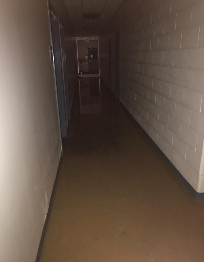 A darkened hallway at Creech Elementary shows receding floodwaters.